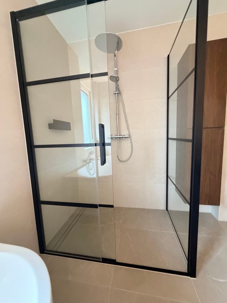Inloopdouche met zwartstalen frame, chromen regendouche en Easydrain-douchegoot in luxe badkamer Waalre
