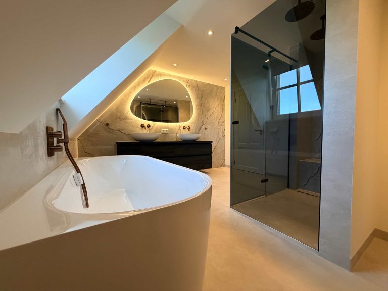 Overzicht van badkamer renovatie in Helmond met vrijstaand bad, inloopdouche met rookglas en dubbele wastafel onder schuin dak
